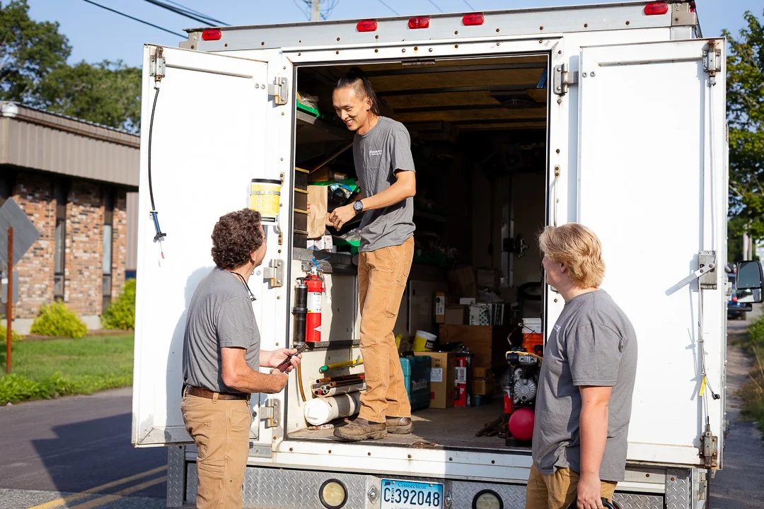 Technicians getting tools from truck