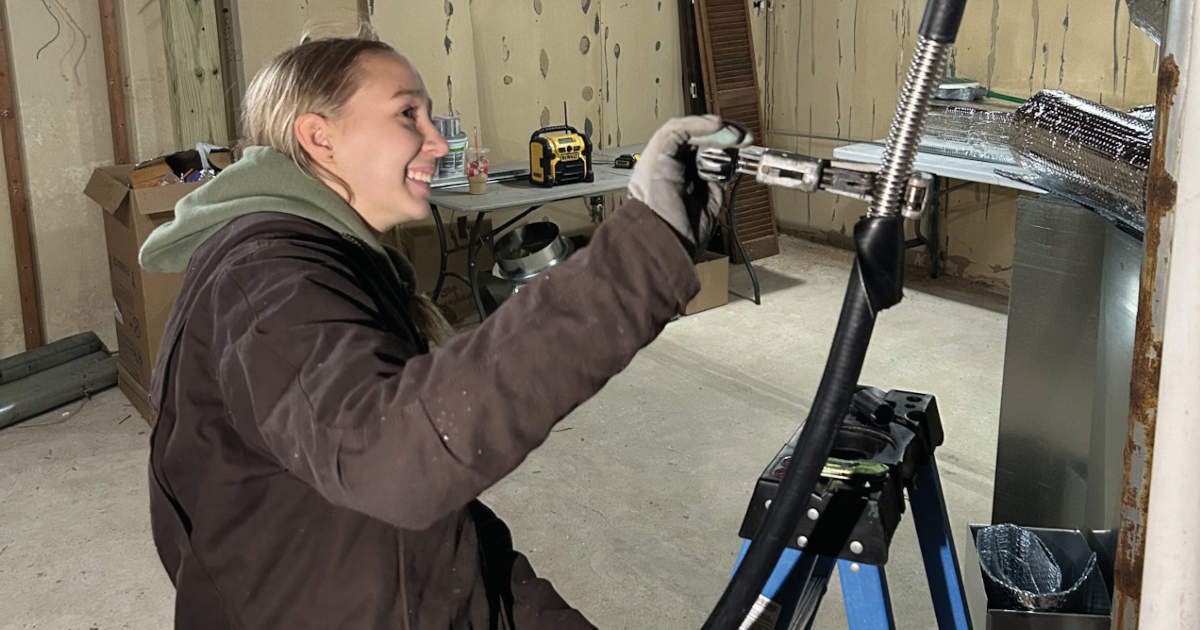 smiling woman working on her HVAC system