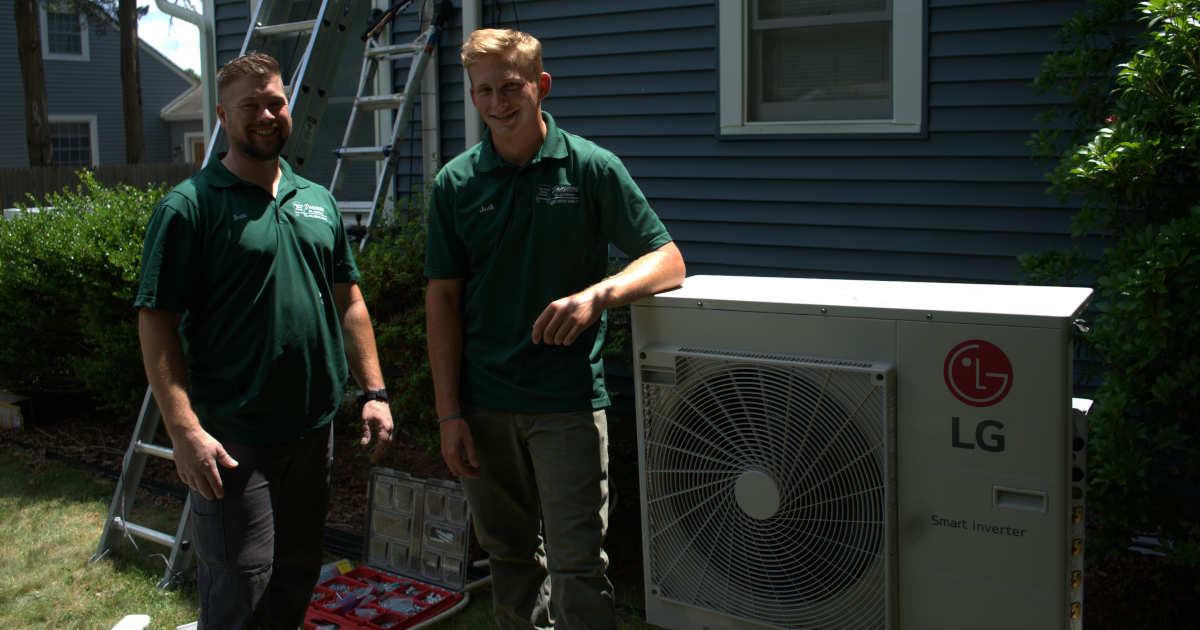 HVAC technicians by air conditioning unit