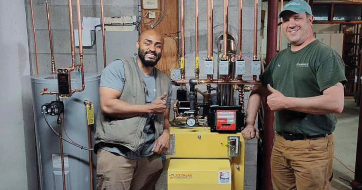 Densmore employees near boiler in basement