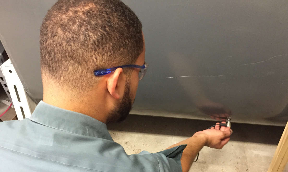 technician doing scan on oil tank